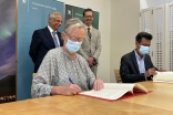 Minister Counsellor of the Norwegian Embassy Sissel Idland (left) and AKF Mozambique National Director Agostinho Mamade (right) signing the grant agreement with the AKDN Diplomatic Representative Nazim Ahmad (left) and the Norwegian Ambassador Haakon Gram-Johannessen (right) looking on.