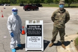 Shama Sarangi-Virani at a COVID-19 test site with a member of the National Guard.