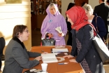 Carla Power signs a copy of her book for guests in attendance.