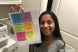 Nabeela Talib displays an example of the product of her computer code, which sends messages from her phone to her printer to print sticky notes.