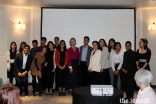 Meredith Preston McGhie, Secretary General of the Global Centre for Pluralism (centre) poses for a group photograph with young members of the Jamat at an institutional dinner in Paris.