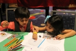 Two young children pick up on subtle themes and messages that were hidden in the Early Childhood section of the Reflections Lounge.