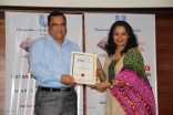 Minister presenting Parvish the award