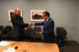 Dr. Mirza Kajani, Chairperson, Aga Khan Health Board for USA, and Greg Szekeres, Deputy Director of UCLA's Center for World Health, exchange documents recording the MOU between Aga Khan Health Service/Aga Khan University and UCLA's School of Medicine.