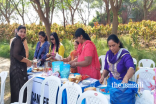 Pait Puja ladies with WAP members at Snack Counter during Youth Sports program in Academy