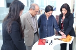 Visitors interacting with artifacts at the Ethics in Action exhibition in Houston, Texas.