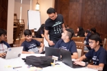 A Hackathon Dubai participant consults with a facilitator to determine if his group is on the right track.