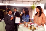 Rozina Piredina receiving an award from Ali Sajjad Taj, Mayor of Artesia, California.