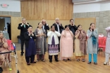 Seniors at Atlanta Northwest Jamatkhana doing face yoga.