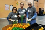 Volunteers packing oranges at the Feeding America San Diego warehouse