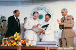 Mawlana Hazar Imam accepts the AKU Charter in 1983 as President Shamsh Kassim-Lakha looks on.