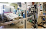 Registered nurse Aubry Sander cares for a COVID-19 patient in a negative pressure room (NPR) at Gulf Coast Medical Center in Fort Myers, Florida. NPR’s help prevents cross-contamination from room to room.