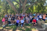 Members of the Ismaili Muslim Students Association pose with the University’s hand sign, “Hook ‘em.”