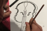 Séance de création artistique en groupe au Jamatkhana de Lyon. Dessin d'un violon.