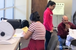 Jamati members get vision screenings.