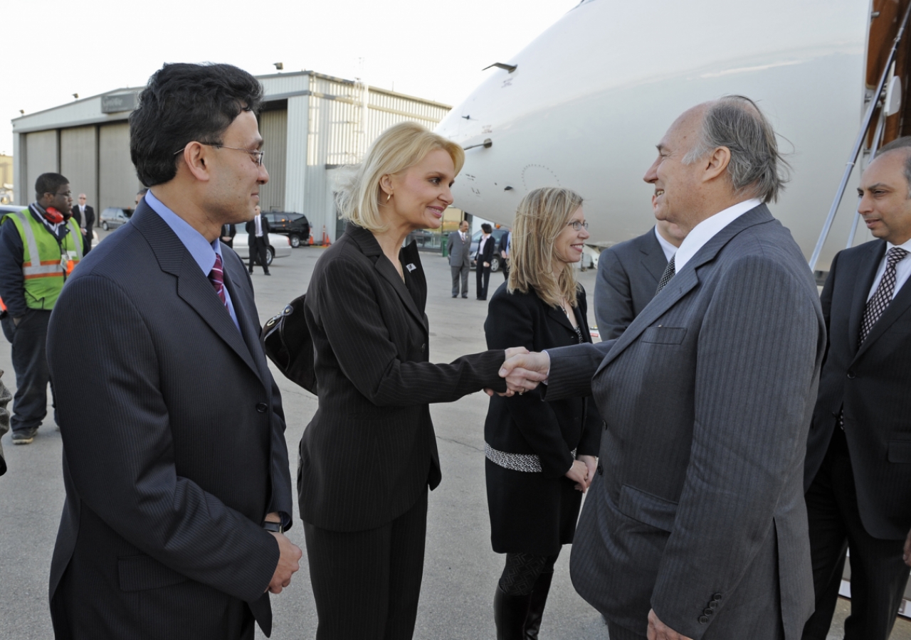 Mawlana Hazar Imam is greeted by Ms. Eva Sieradzki, Director of International Relations and Protocol at the office of the Governor of Illinois. The President of the Ismaili Council for the Midwestern USA looks on.  