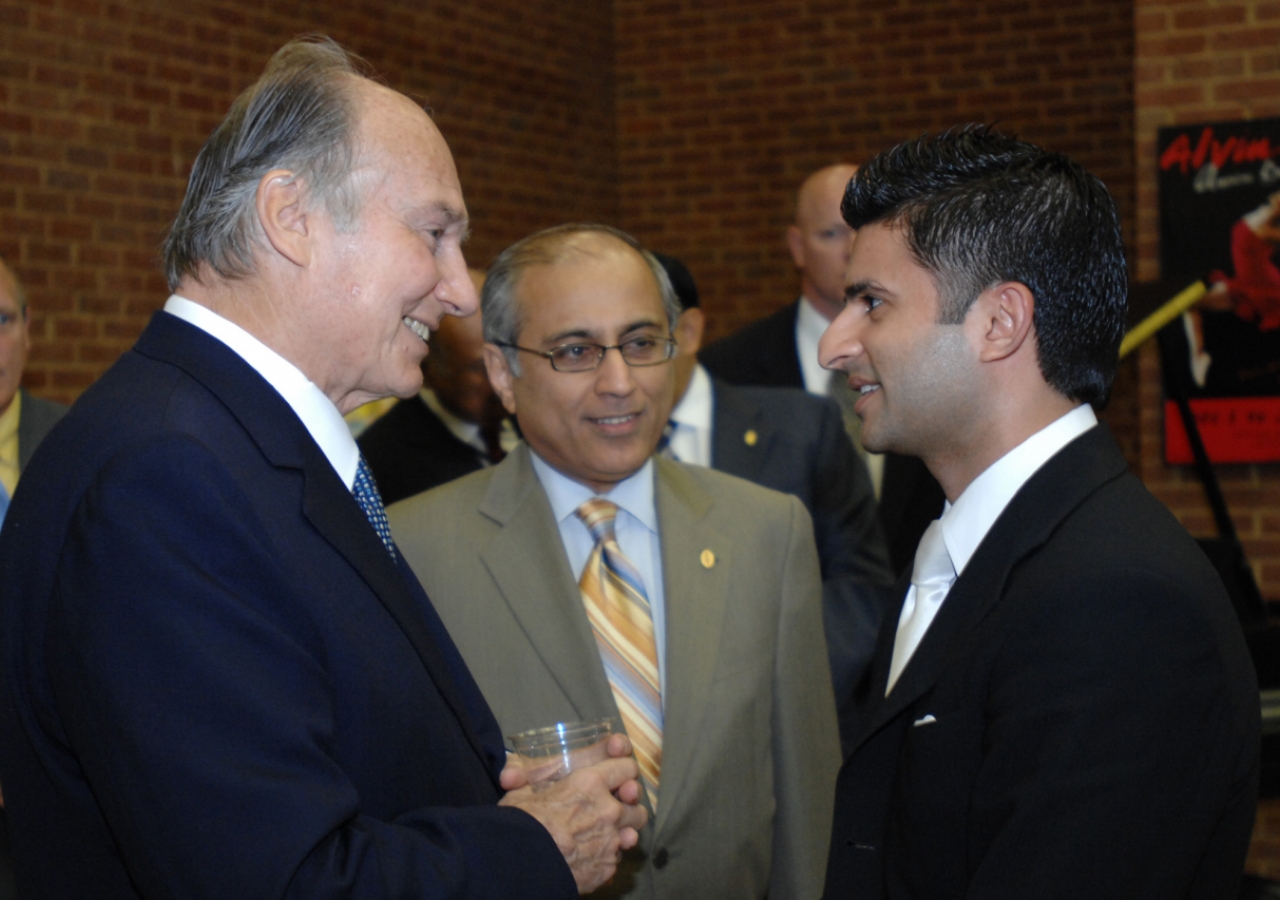 Mawlana Hazar Imam in conversation with an Ismaili involved in the field of Education. Salim Bhatia, Director of the Aga Khan Academies Programme looks on.  