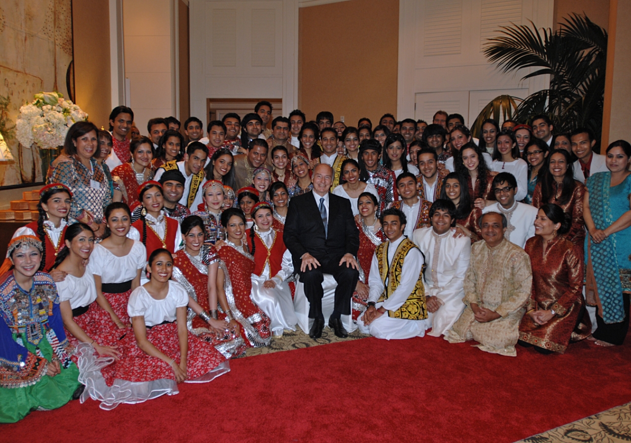 Mawlana Hazar Imam poses for a photograph with the musicians, singers and dancers who had performed earlier in the evening. 