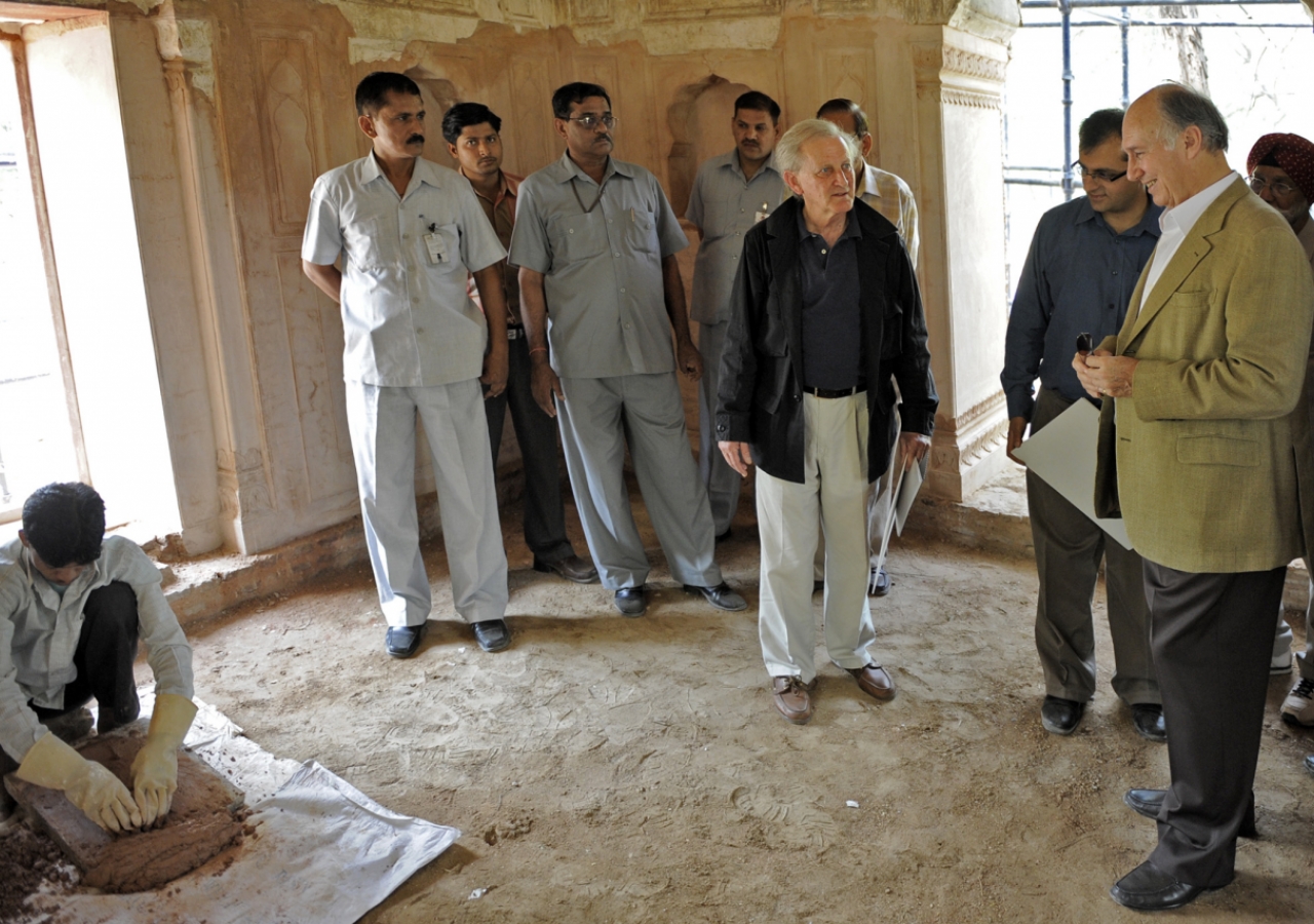 Mawlana Hazar Imam observes as a local craftsman demonstrastes restoration techniques. 