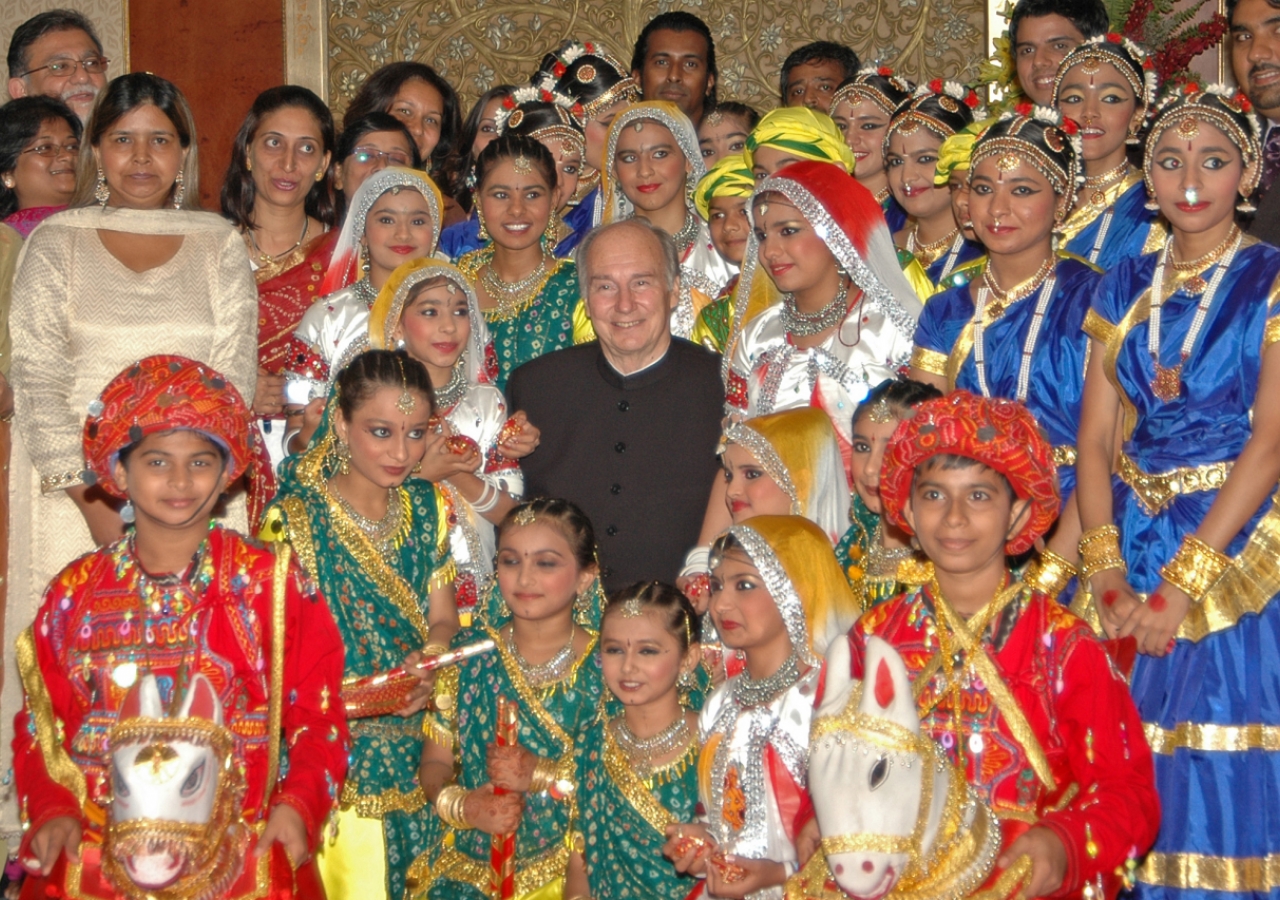 Mawlana Hazar Imam together with performers who had danced earlier in the evening at the Jamati institutional dinner.    