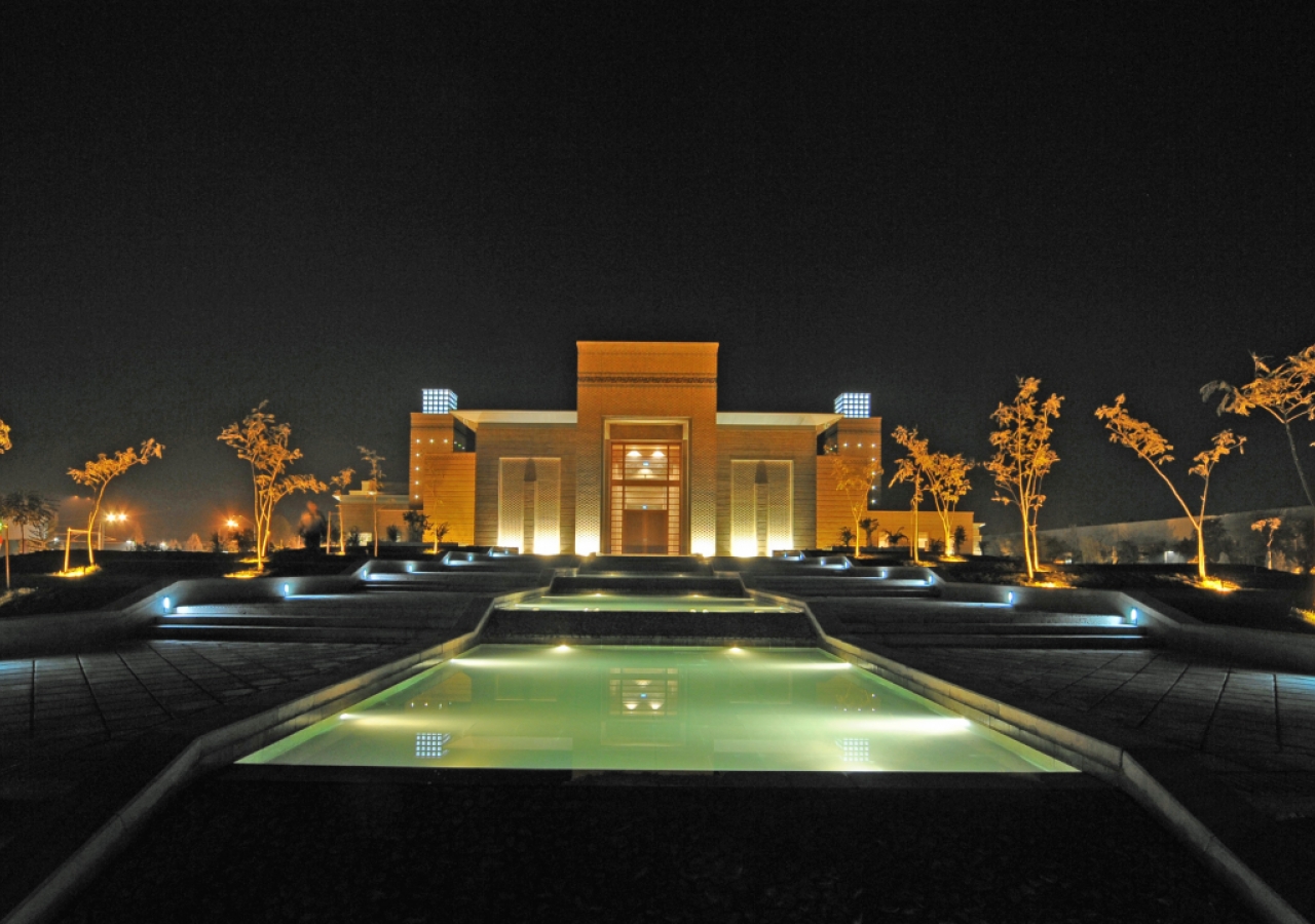 An evening view of the Ismaili Centre, Dushanbe. Pedestrian walkways line the cascading water feature, leading to the building’s Main Entrance.