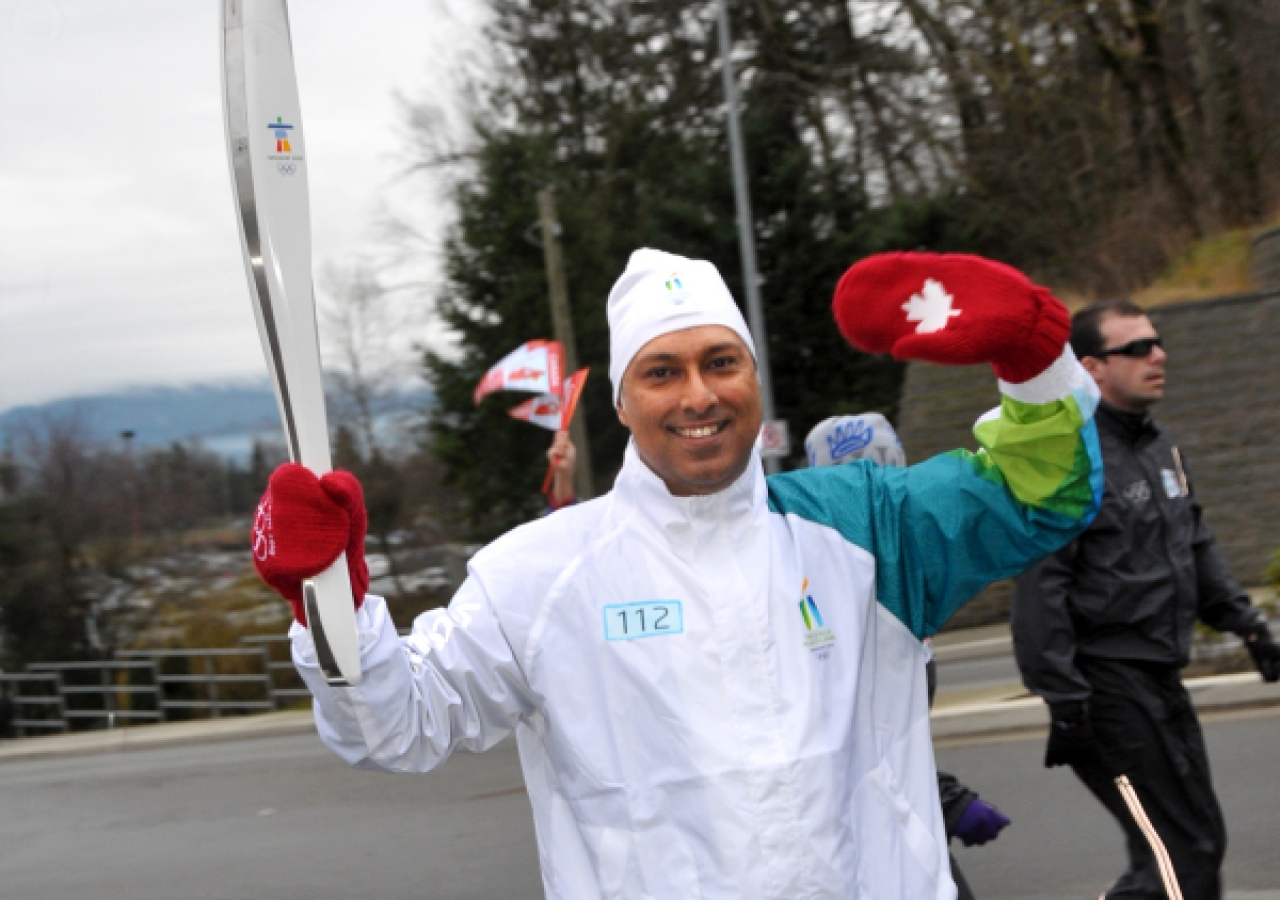 Pharid Jaffer carries the Olympic flame in Abbotsford, British Columbia.