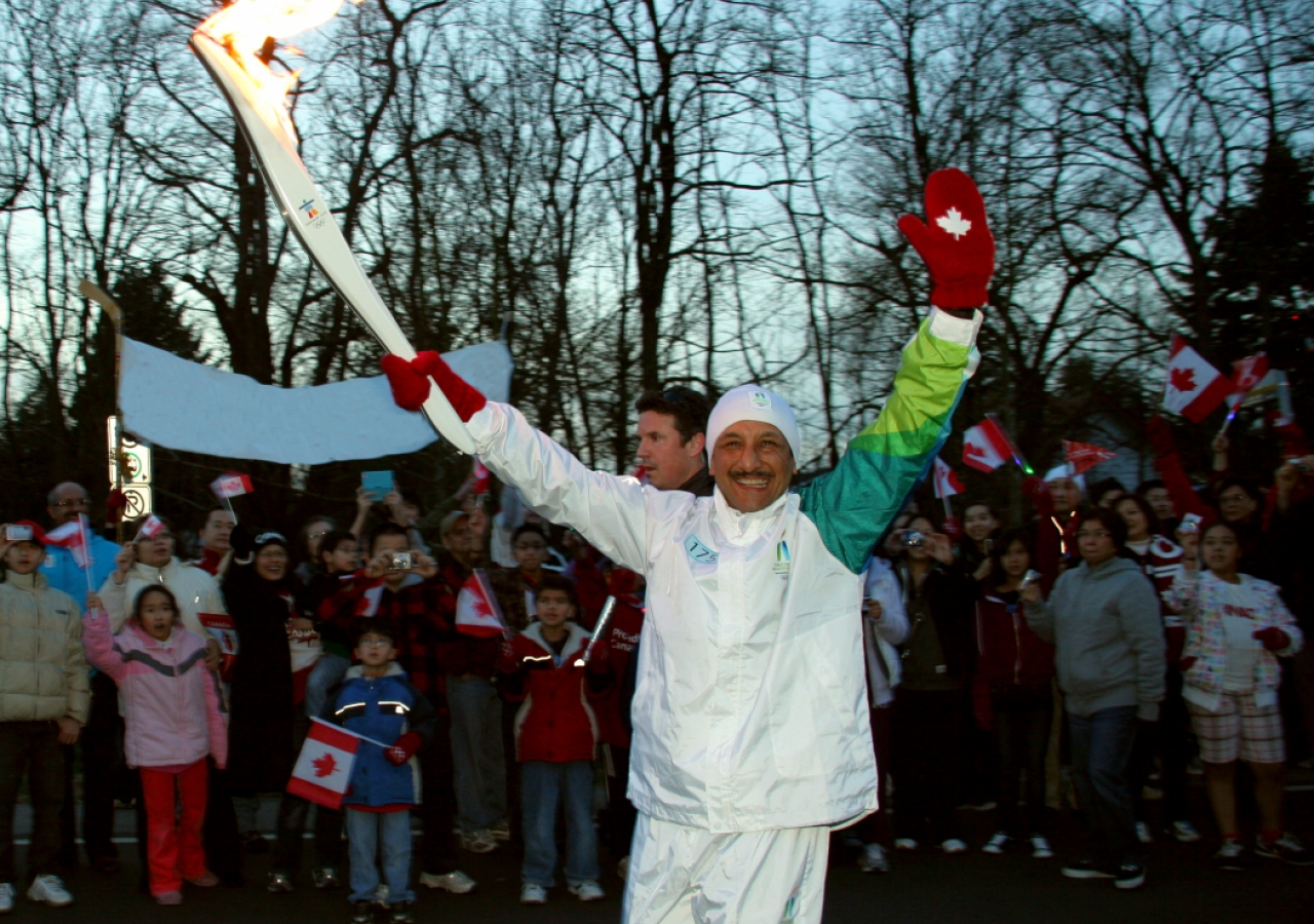 Akber Dhanjee celebrates his torch relay run.