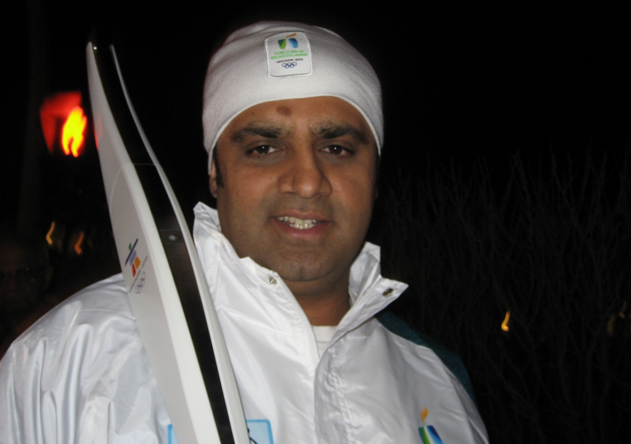 Farhan Lalji poses for a photograph with his Olympic torch in Kamloops, British Columbia.