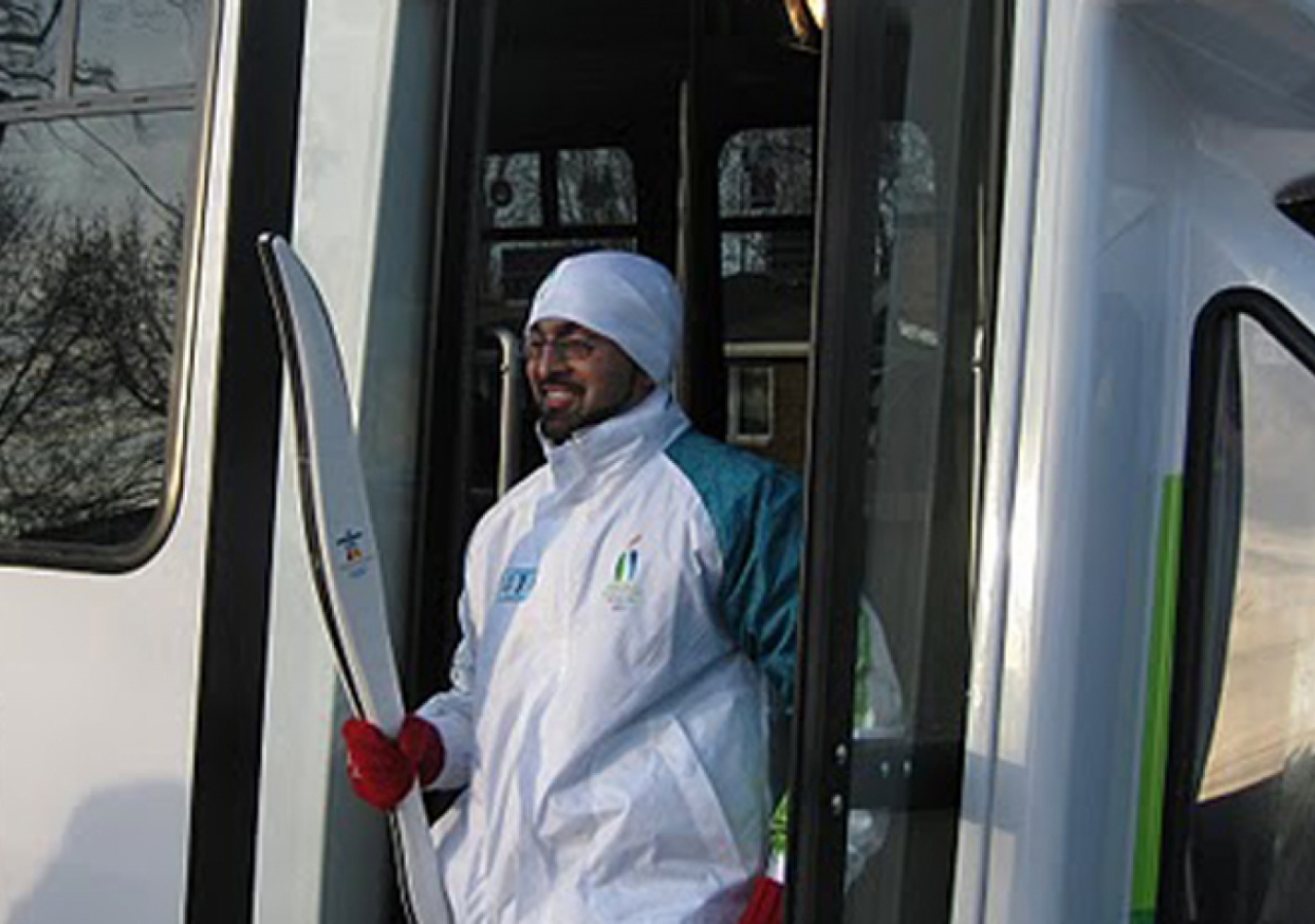 Aziz Shariff steps off the official Torch Relay bus in LaSalle, Ontario in anticipation of his run with the Olympic flame.