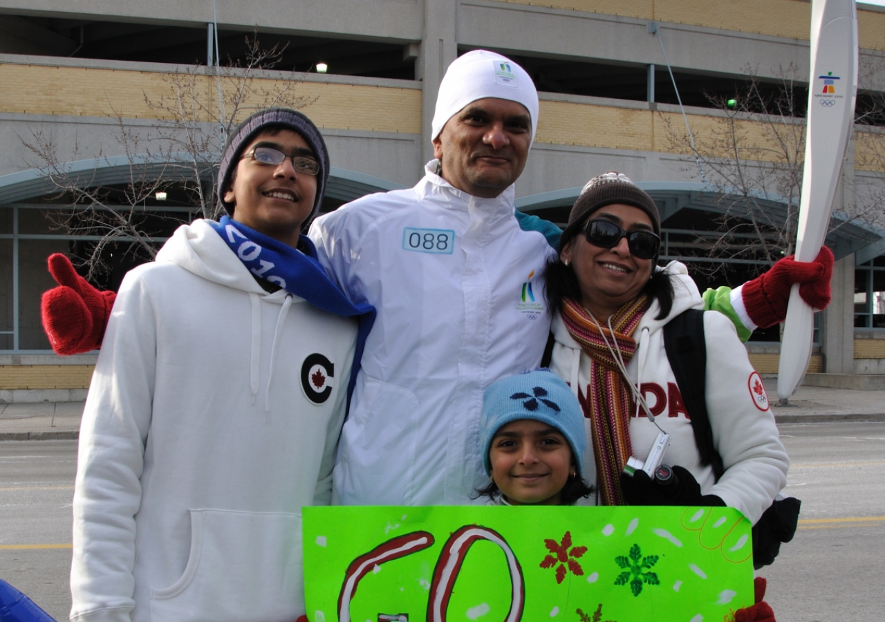 Salim Patel is cheered on by his family as he prepares to run in the Olympic Torch Relay in Mississauga, Ontario.