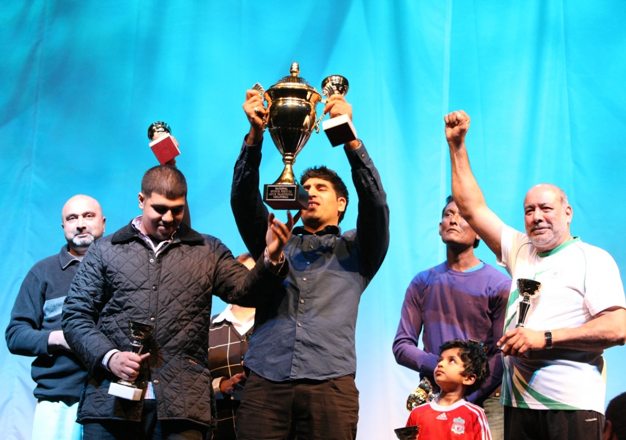 Traditional Volleyball winners celebrate their trophy.