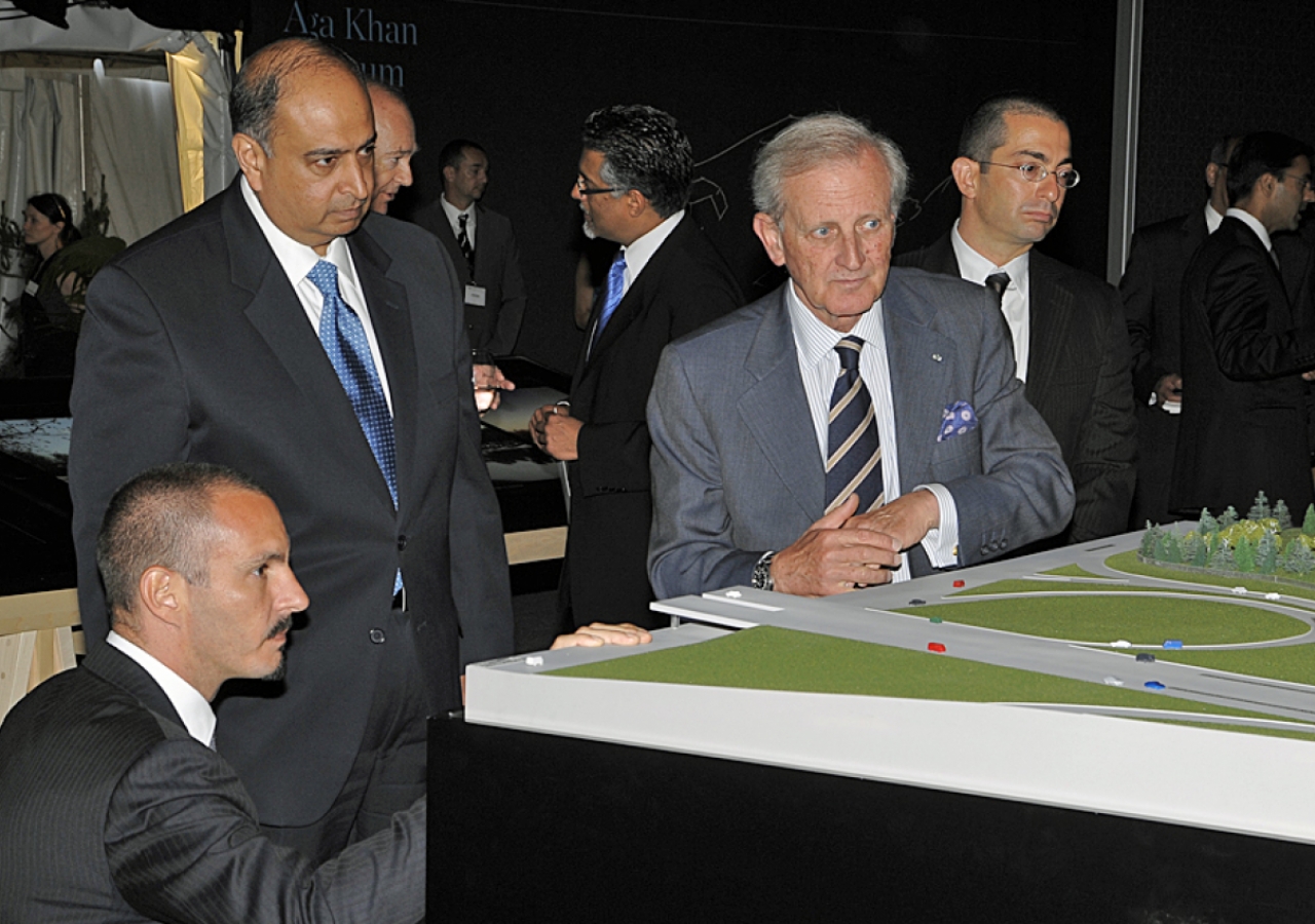 Prince Rahim gets an eye-level look at the architectural model, as Ismaili Council for Ontario President Karim Sunderji, AKTC General Manager Luis Monreal and landscape architect Vladimir Djurovic look on.