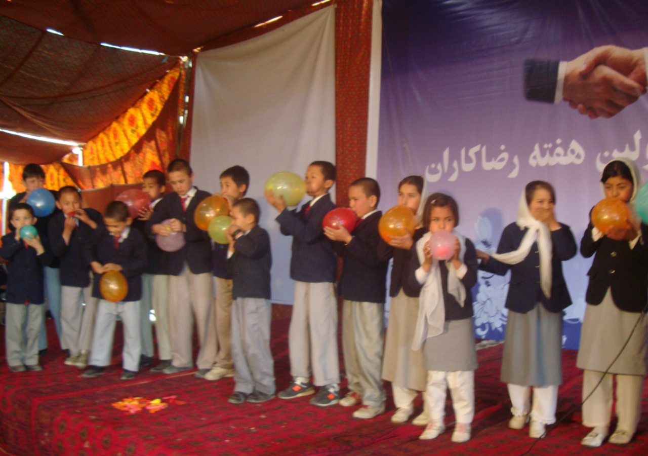 Junior volunteers compete in a balloon-blowing contest &amp;mdash; part of the fun and games of Volunteer Week in Afghanistan.