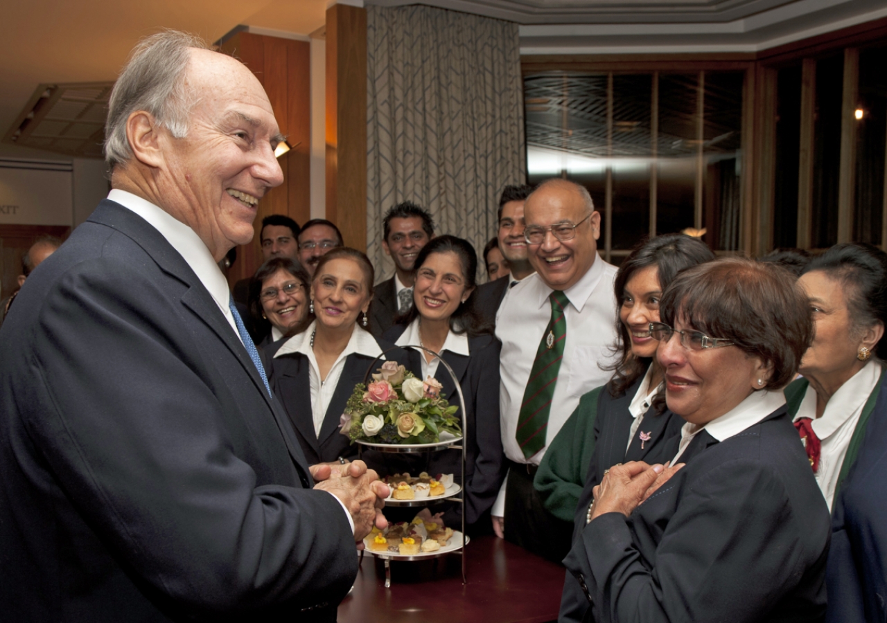 Mawlana Hazar Imam stops to speak with volunteers at a tea party for Prince Charles&amp;rsquo; visit commemorating the 25th anniversary of the Ismaili Centre, London.