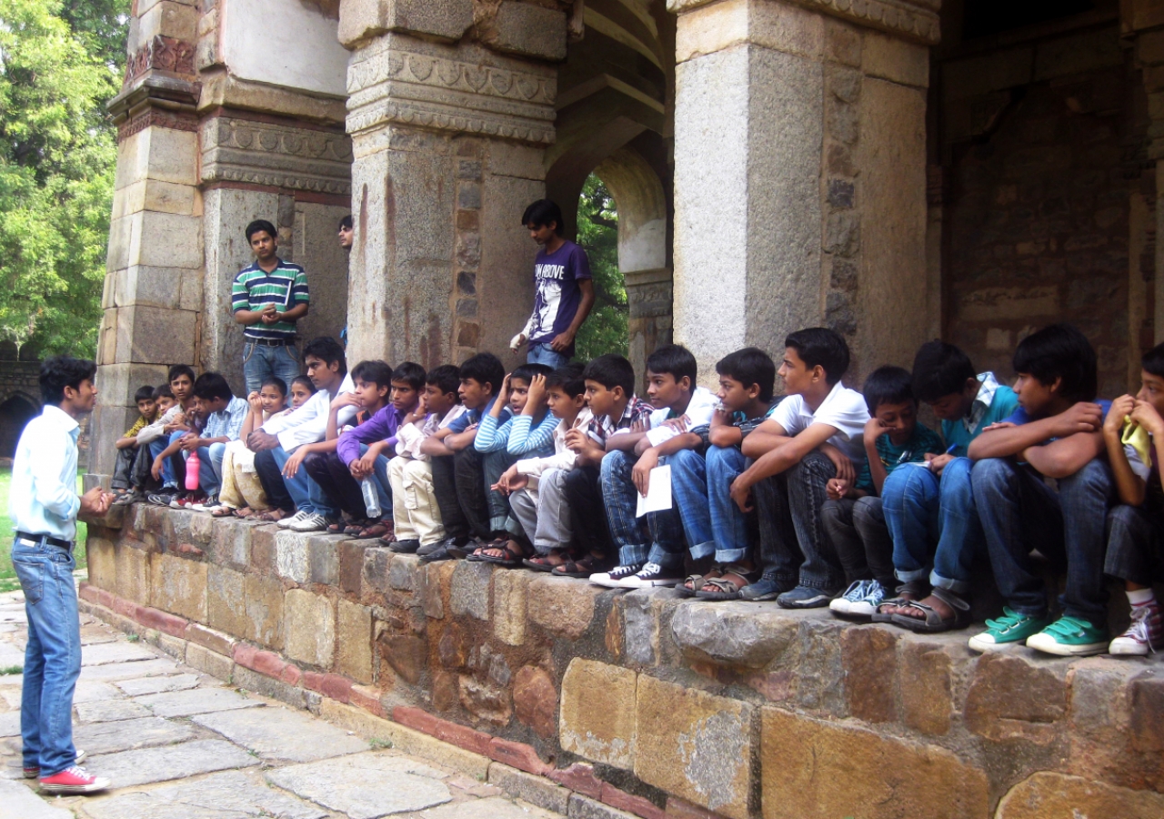 AKTC-trained heritage volunteers from Nizamuddin Basti teach young children about their rich cultural heritage at the 16th century Isa Khan tomb.