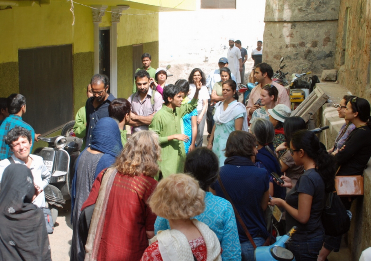 A guide trained by AKTC leads visitors on a tour of the Nizamuddin Basti.