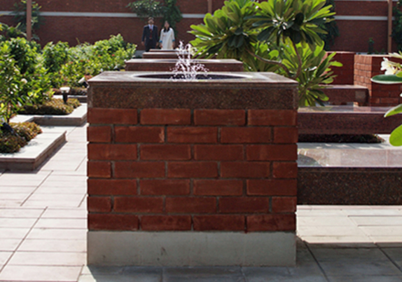 Water sprinkles from a courtyard fountain at the Ismaili Jamatkhana Lahore.