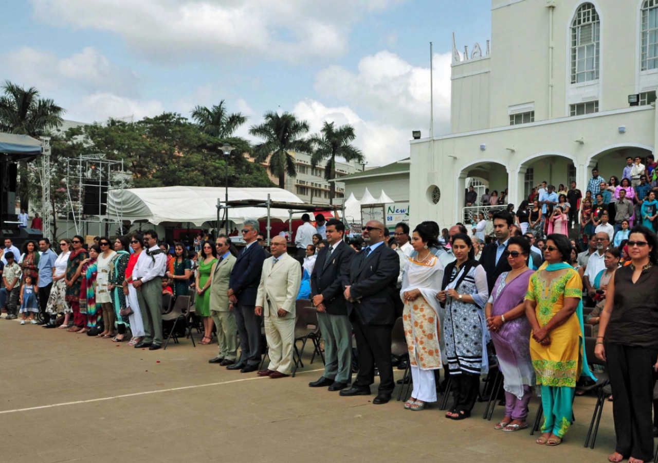 Leaders and members of the Jamat line up outside of Kampala Jamatkhana to witness the flag raising ceremony.