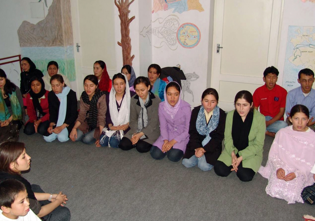 Tahmina Shayan with other teachers and students celebrate Afghanistan’s culture through song, poetry and dance, in a room they worked together to decorate.