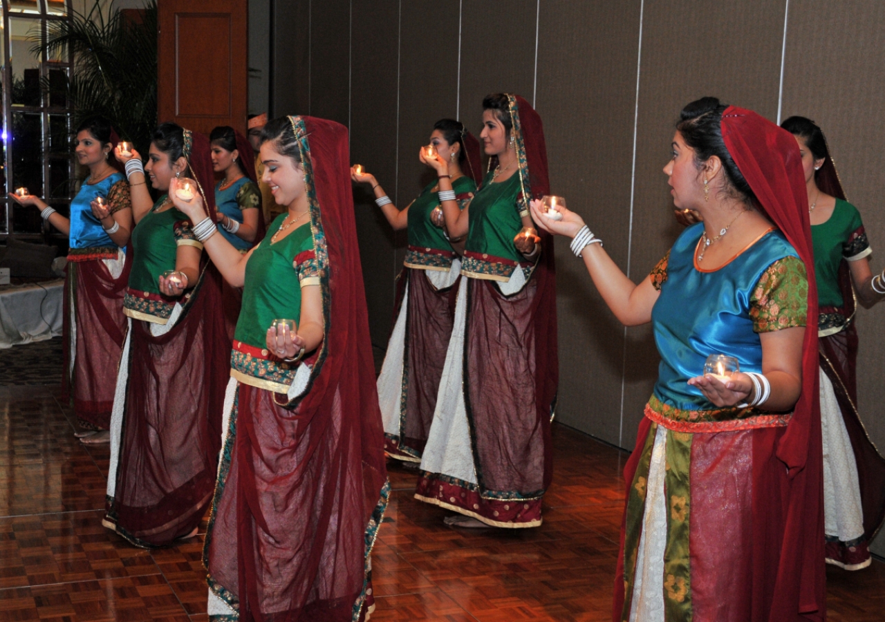 Youth from the Far East Jamat perform a candle dance before Mawlana Hazar Imam.