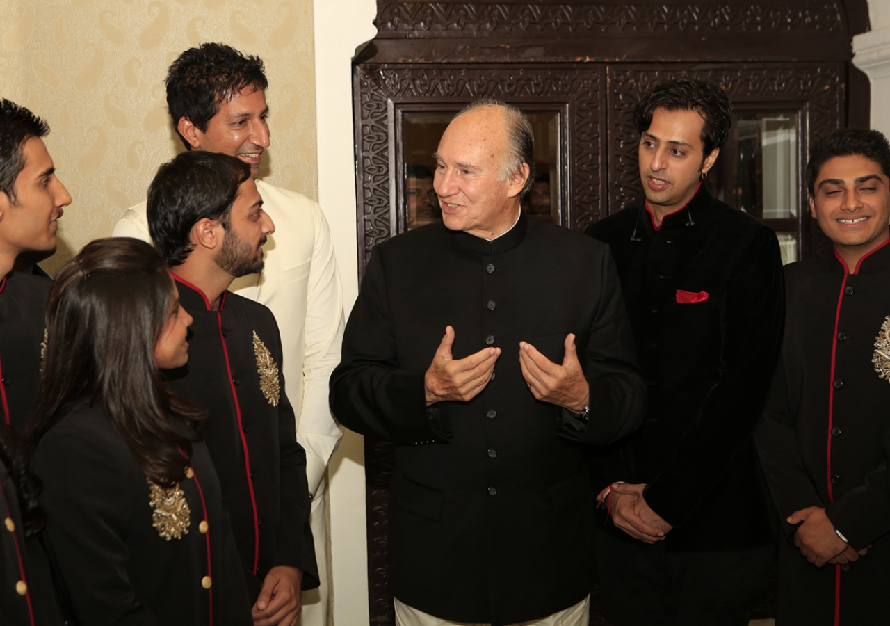 Mawlana Hazar Imam speaks with murids who performed at the institutional banquet.