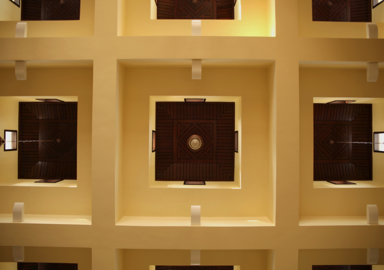 Chandeliers hang from a coffered ceiling inside the Ismaili Jamatkhana and Centre, Kinshasa.