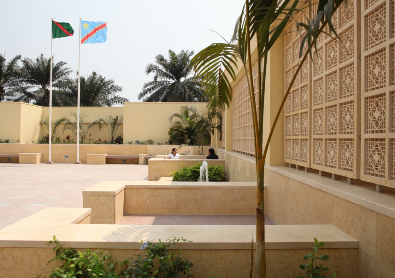 Two flagpoles stand at the end of the Grand Courtyard of the Ismaili Jamatkhana and Centre, Kinshasa.