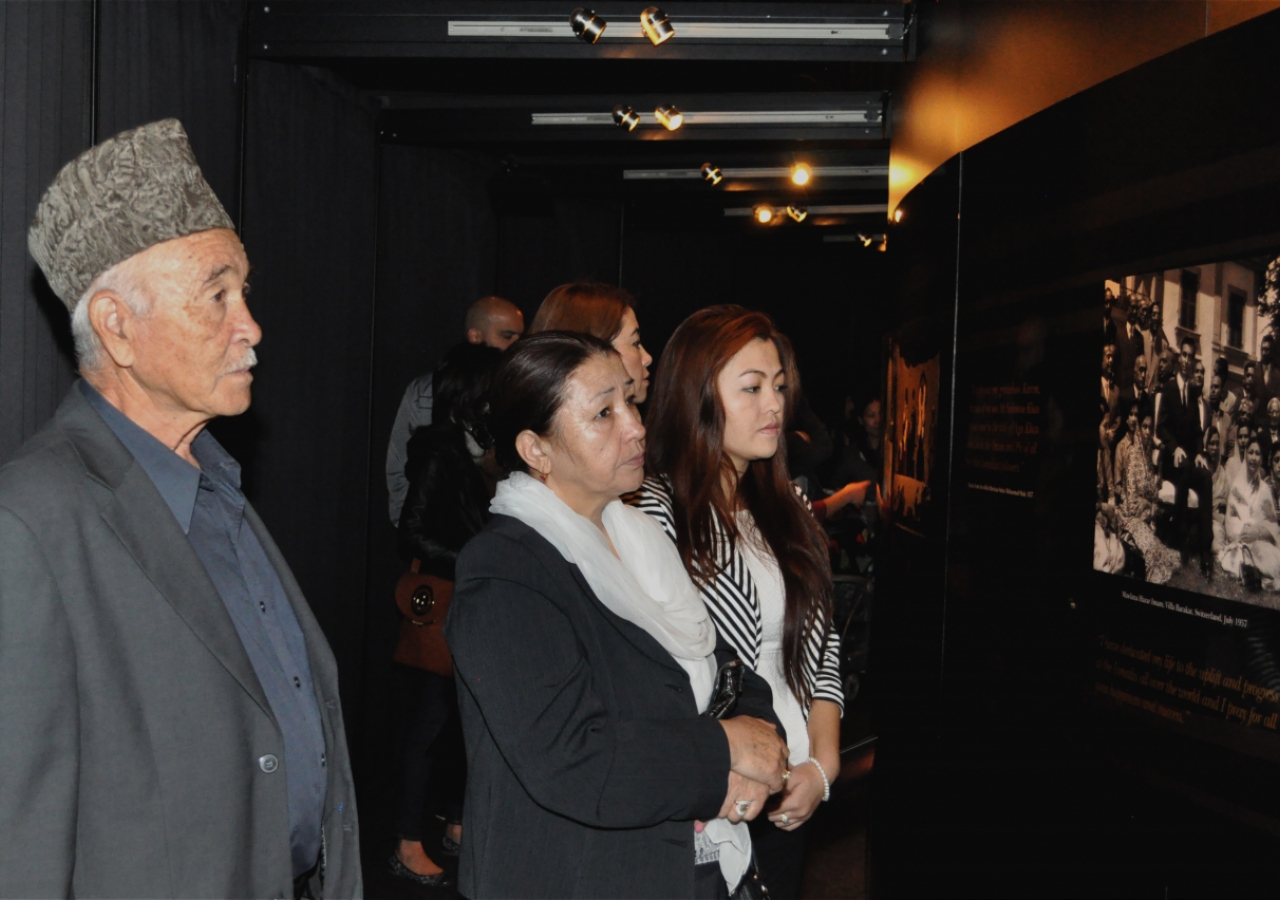 Jamati members look upon a photograph of Mawlana Hazar Imam taken at Villa Barakat, Switzerland in 1957, at the dawn of his Imamat.