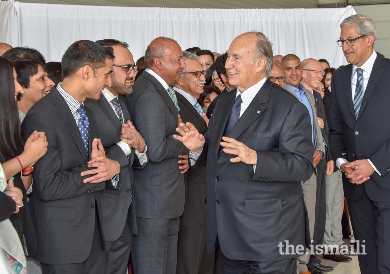 Mawlana Hazar Imam shares a light moment with Jamati representatives upon his arrival in Calgary.