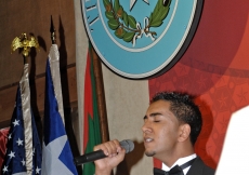 Shanil Wazirali sings the US National Anthem at the opening of the Texas State Gala. 