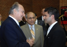 Mawlana Hazar Imam in conversation with an Ismaili involved in the field of Education. Salim Bhatia, Director of the Aga Khan Academies Programme looks on.  