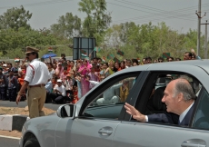 Mawlana Hazar Imam waves at members of the Jamat who lined the streets around Hyderabad airport to welcome him.   