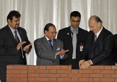 Mawlana Hazar Imam lays a brick during the foundation ceremony of the Ismaili Jamatkhana and Centre in Dhaka, as President Habib Hirji of the Ismaili Council for Bangladesh (left) and the Honourable Adviser for Foreign Affairs, Dr. Iftekhar Ahmed Chowdhur