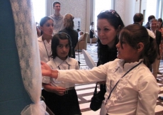 Students from the Aga Khan Lycée in Khorog explain a winning science fair project to guests at the Imamat Day Reception.